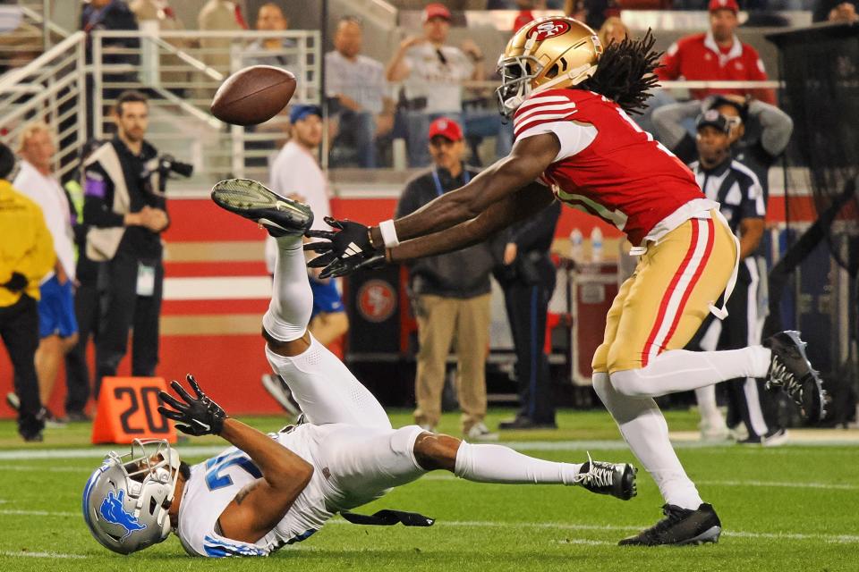 San Francisco 49ers wide receiver Brandon Aiyuk reaches for the ball after it bounced off the helmet of Lions cornerback Kindle Vildor in the second half of Sunday's NFC championship game.