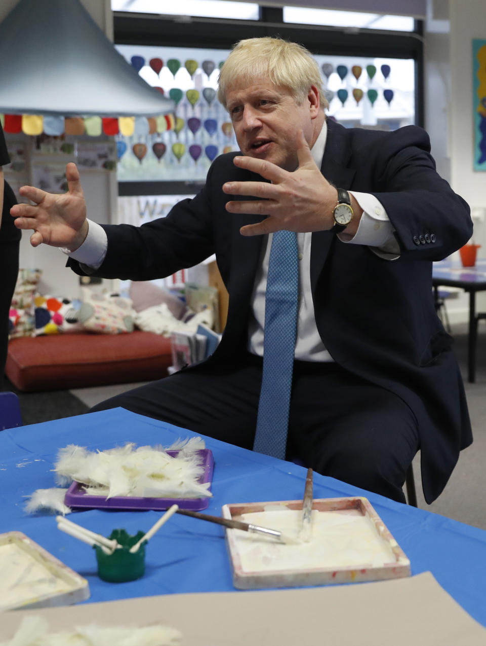 Britain's Prime Minister Boris Johnson gestures as he participates in an art class at St Mary's and All Saints Primary School in Beaconsfield, England, Friday, Oct. 11, 2019. (AP Photo/Alastair Grant, Pool)