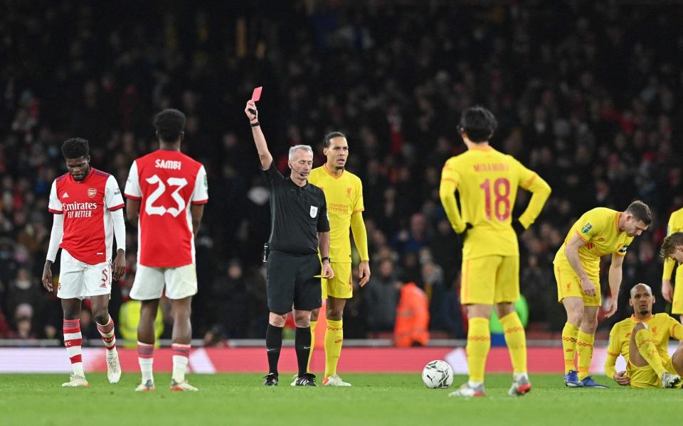 Referee Martin Atkinson shows a red card to Arsenal's Ghanaian midfielder Thomas Partey -  JUSTIN TALLIS/AFP via Getty Images