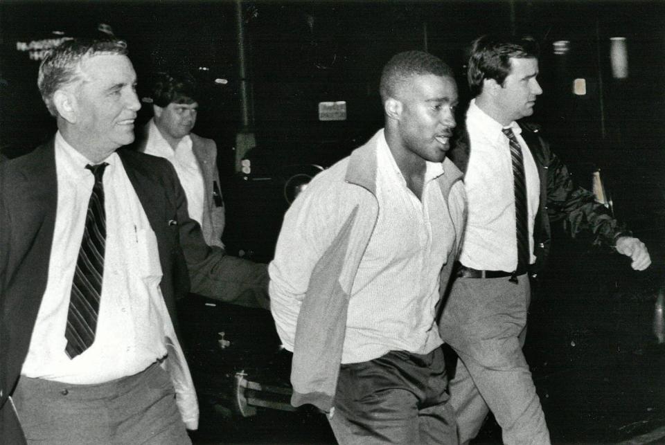 In 1988 detective Jim Geisenburg (left) and Sgt. Randy Hammond (right) escort Michael Wesley Turner, the suspect in the beating of a sheriff's officer, to the Duval County jail. Turner was sentenced to a life term for the attempted murder of the officer and died in prison in 2015. Geisenburg was the father of author Julie Delegal, whose book, "Seen," is about a murder trial in a fictional city much like Jacksonville.