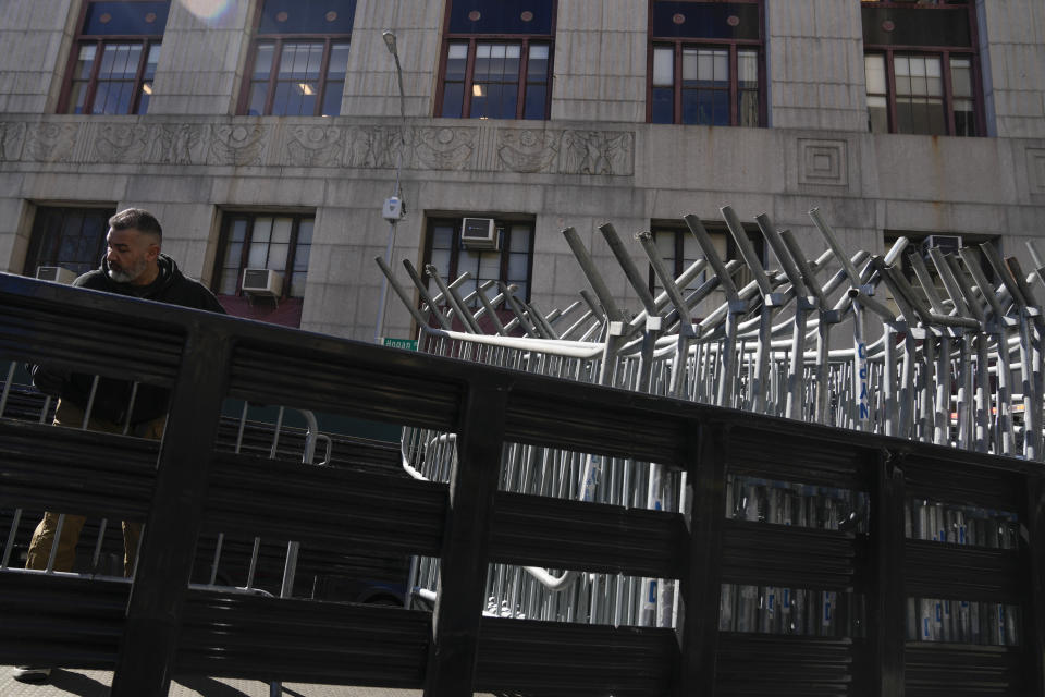 Barricades are unloaded from a truck near the courts in New York, Monday, March 20, 2023. (AP Photo/Seth Wenig)