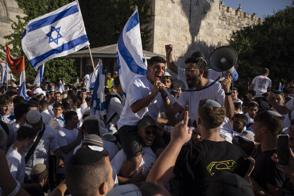 Israelis shout slogans and wave national flags during a march marking Jerusalem Day, an Israeli holiday celebrating the capture of east Jerusalem in the 1967 Mideast war, in front of the Damascus Gate of Jerusalem's Old City, Wednesday, June 5, 2024. Thousands of mostly ultranationalist Israelis are taking part in an annual march through a dense Palestinian neighborhood of Jerusalem’s Old City. (AP Photo/Leo Correa)