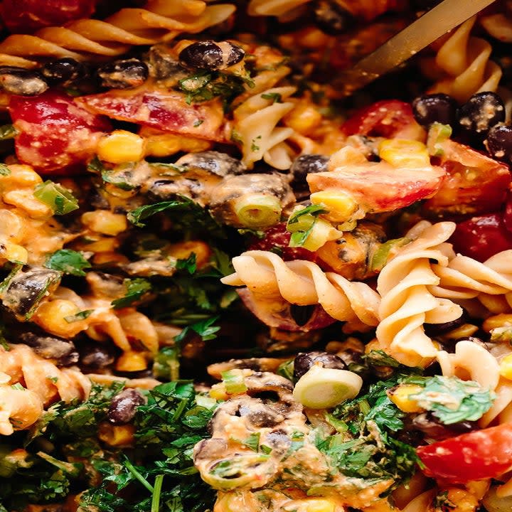 a close-up of southwest pasta with beans and tomato