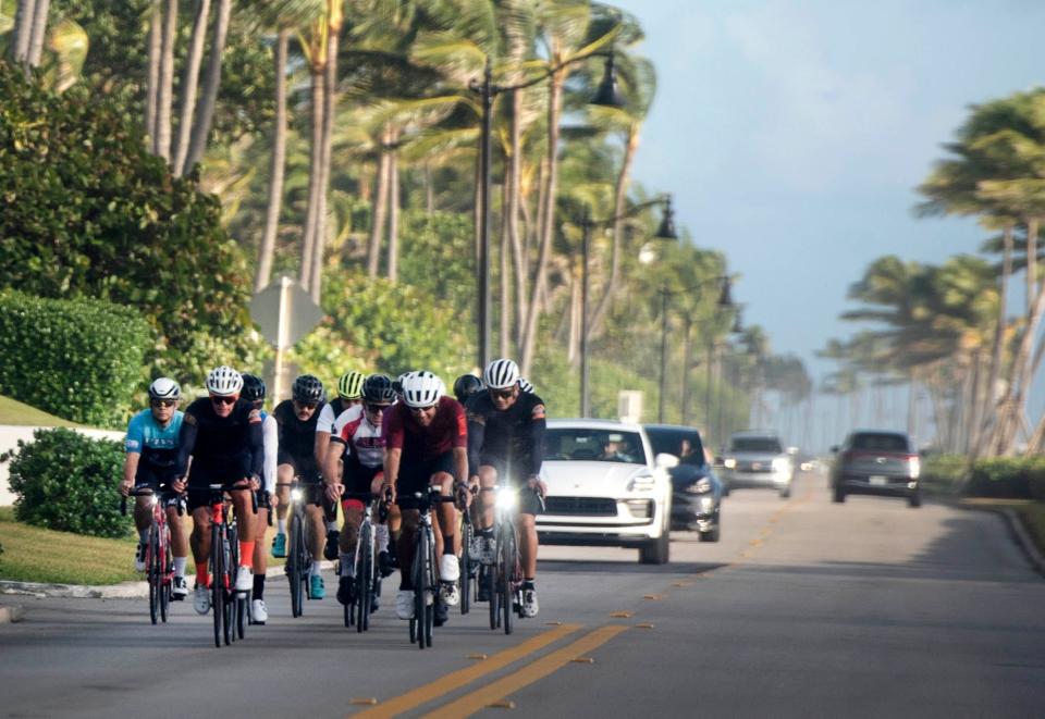 Cyclists ride south along South Ocean Boulevard on Oct. 28. According to the Palm Beach Police Department, bicyclists must ride single file on the substandard width roads in town, unless temporarily avoiding a hazard or overtaking another bicyclist.