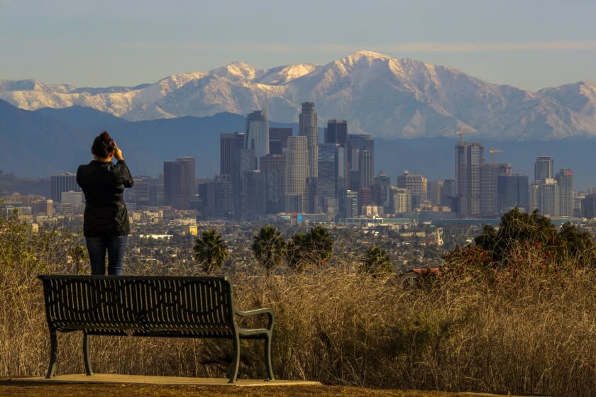 LOS ANGELES, CA - NOVEMBER 30, 2019 — A view downtown Los Angeles skyline from Kenneth Hahn State Recreation Area, against the backdrop of snow covered mountains on November 30, 2019, Los Angeles. There is a significant chance of rain late afternoon. (Irfan Khan / Los Angeles Times)
