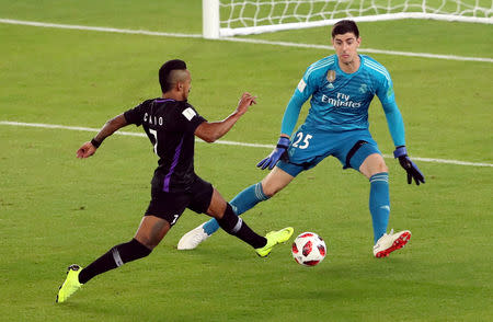 Soccer Football - Club World Cup - Final - Real Madrid v Al Ain - Zayed Sports City Stadium, Abu Dhabi, United Arab Emirates - December 22, 2018 Al-Ain's Caio in action with Real Madrid's Thibaut Courtois REUTERS/Ahmed Jadallah