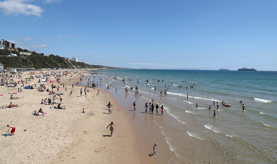 People visit the beach in Bournemouth as parts of the UK enjoy warm weather.