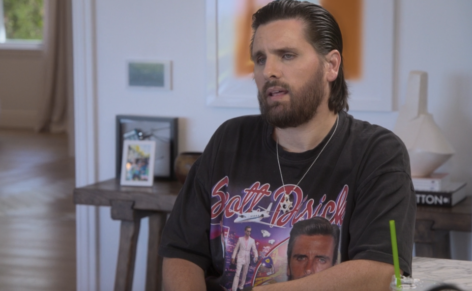 Close-up of Scott wearing a "Scott Disick" T-shirt