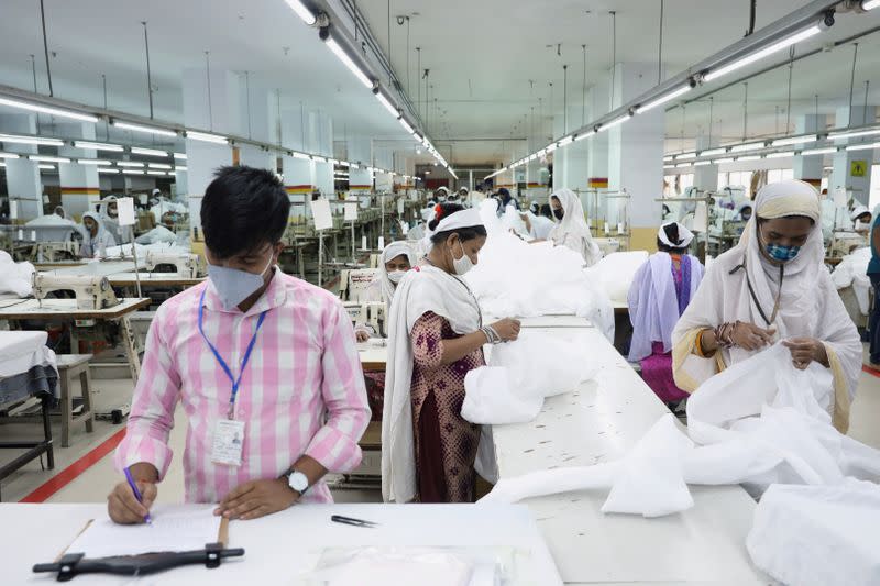 Bangladeshi garment workers make protective suit at a factory amid concerns over the spread of the coronavirus disease (COVID-19) in Dhaka