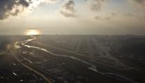 An aerial view from a helicopter shows runways of the Sochi International Airport (Sochi-Adler Airport) in the Black Sea resort city of Sochi, December 23, 2013. Sochi will host the 2014 Winter Olympic Games in February. Picture taken December 23, 2013. REUTERS/Maxim Shemetov (RUSSIA - Tags: CITYSPACE SPORT OLYMPICS TRANSPORT)