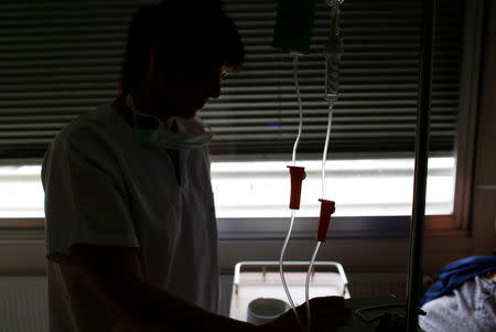 French nurse Anne Besnier treats a patient at the hospital of Laval, France, November 8, 2018. Picture taken November 8, 2018. REUTERS/Stephane Mahe