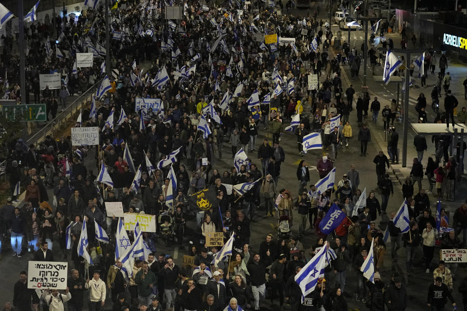 Right-wing Israelis block a main road as they rally in support of plans by Prime Minister Benjamin Netanyahu's government to overhaul the judicial system, in Tel Aviv, Israel, Thursday, March 30, 2023. (AP Photo/Ariel Schalit)