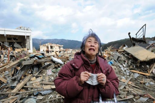 An elderly woman cries in front of a destroyed building in the devastated town of Rikuzentakata in Iwate prefecture. Crews fighting to cool reactors at Japan's stricken nuclear plant hoped Sunday to switch partial power back on after a natural disaster that has left nearly 20,000 people dead or missing