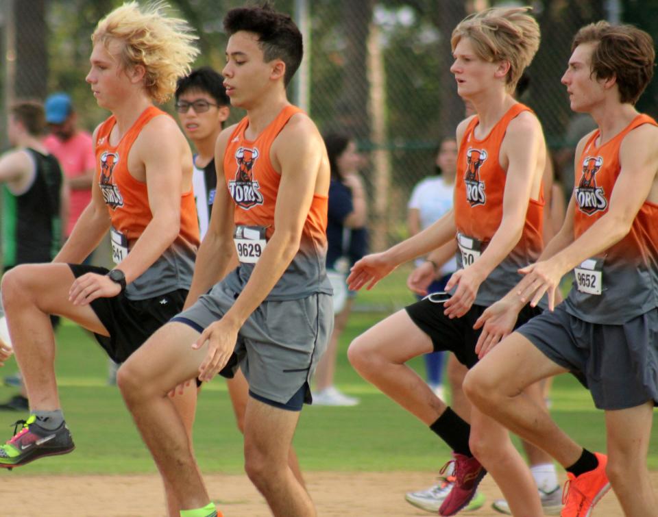 Tocoi Creek runners warm up before the boys varsity high school cross country race at the Katie Caples Invitational.