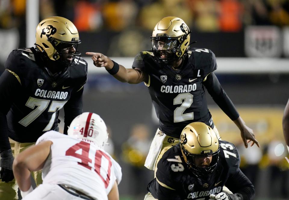 Colorado quarterback Shedeur Sanders directs teammates during the first half of an NCAA college football game against Stanford on Friday, Oct. 13, 2023, in Boulder, Colo.