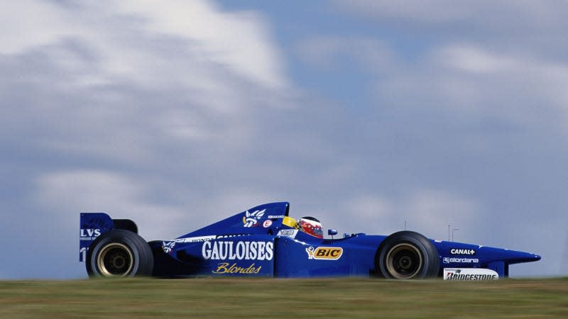 A photo of the 1997 Prost F1 car racing in Brazil. 