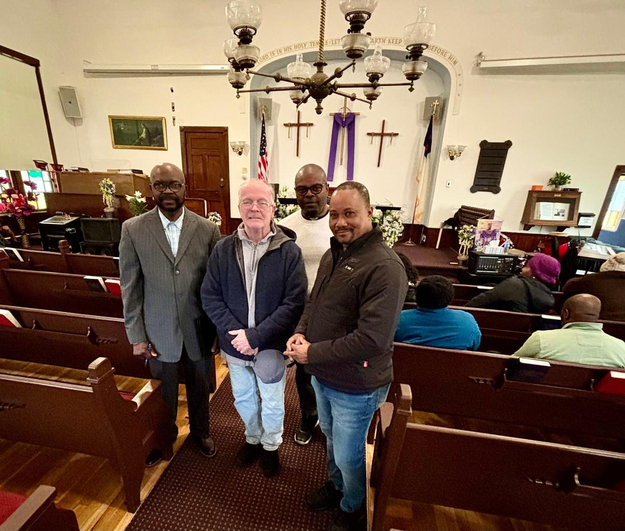 The Haitian Primitive Church of Taunton rents sanctuary space for its members inside North Taunton Baptist Church. Seen here on Friday, April 12, 2024, from left, are Pastor Moise Jecrois, Baptist Pastor John Coppinger, Etzer Julien, a deacon of the Haitian church, and Haitian church bible study teacher Fritz Augustin.