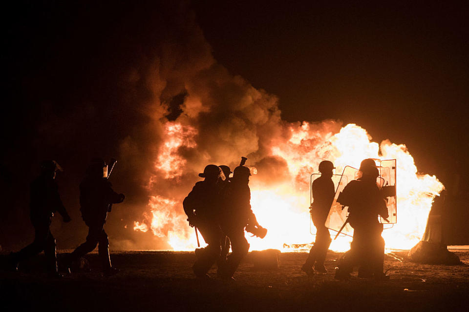 Fires raged during violent clashes between riot police and migrants in Calais