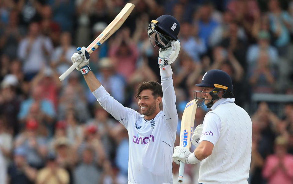 England's Ben Foakes (L) is congratulated by England's Ollie Robinson (R) as he celebrates reaching his century during play on day 2 of the second Test match between England and South Africa at the Old Trafford cricket ground in Manchester on August 26, 2022