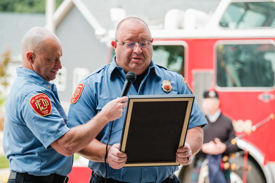 Captain Joseph Minocchi reads an official proclamation from Ohio Senator Al Landis during the celebration of the Dover Fire Department's 150th year of operation, Sunday, May 21 at the Dover Fire Department’s north station. Holding the microphone for Minocchi is Captain Brooks Ross.