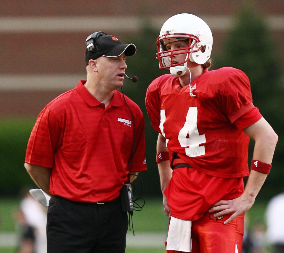 Louisville's Hunter Cantwell, right is given instruction from Jeff Brohm during a spring football game Friday, April 18, 2008 in Louisville, Ky.  