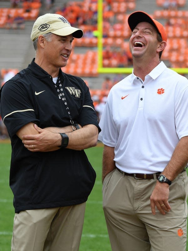 Wake Forest head coach Dave Clawson, left, talks with Clemson head coach Dabo Swinney during pre-game on Saturday, October 7, 2017 at Clemson's Memorial Stadium.