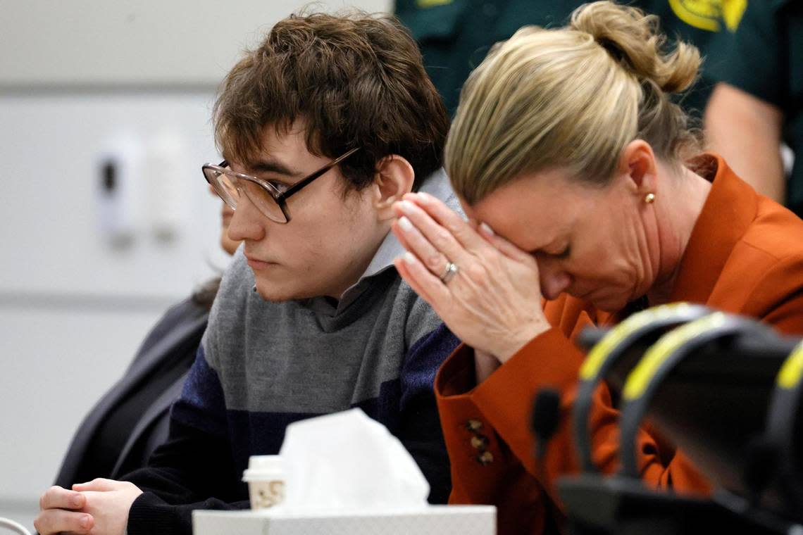 Assistant Public Defender Melisa McNeill, seated with Marjory Stoneman Douglas High School shooter Nikolas Cruz touches her hands to her head as the last of the 17 verdicts were read in the penalty phase of Cruz’s trial at the Broward County Courthouse in Fort Lauderdale on Thursday, Oct. 13, 2022. Cruz, who pleaded guilty to 17 counts of premeditated murder in the 2018 shootings, is the most lethal mass shooter to stand trial in the U.S. He was previously sentenced to 17 consecutive life sentences without the possibility of parole for 17 additional counts of attempted murder for the students he injured that day.