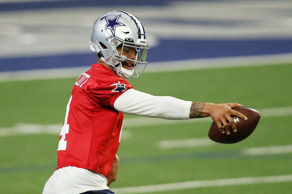 Cowboys quarterback Dak Prescott goes through drills during minicamp on Tuesday.