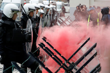 Protesters wearing yellow vests, a symbol of a drivers' protest against higher fuel prices, face off with police during a demonstration in central Brussels, Belgium, November 30, 2018. REUTERS/Yves Herman