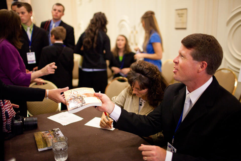 WASHINGTON - SEPTEMBER 17: Michelle Duggar and Jim Bob Duggar, stars of The Learning Channel TV show '19 Kids and Counting,' pose for a picture with a fan while signing copies of their book at the Values Voter Summit on September 17, 2010 in Washington, DC. The annual summit drew nearly two thousand people to advocate for conservative causes. (Photo by Brendan Hoffman/Getty Images)