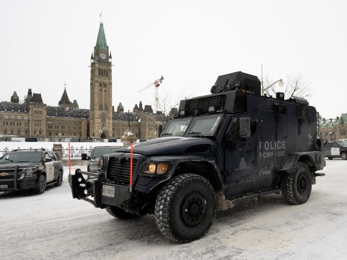 An RCMP tactical vehicle drives past the Parliament buildings on Sunday, Feb. 20, 2022 in Ottawa. (Adrian Wyld/The Canadian Press - image credit)