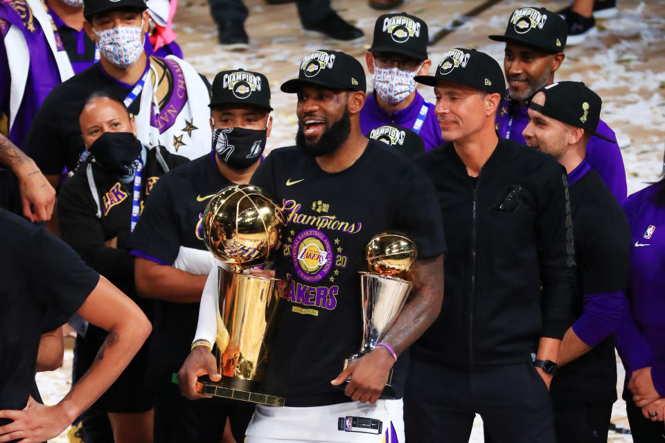 LeBron James Holding NBA Finals Trophy And NBA Finals MVP Trophy