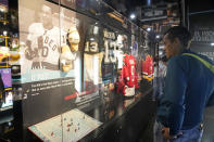 Jason Switek, of Fort Lauderdale, Fla., views the exhibits inside the United Hockey Mobile Museum, Thursday, Feb. 2, 2023, in Fort Lauderdale. The museum highlights the contributions of underrepresented communities and women to the sport of hockey. (AP Photo/Marta Lavandier)