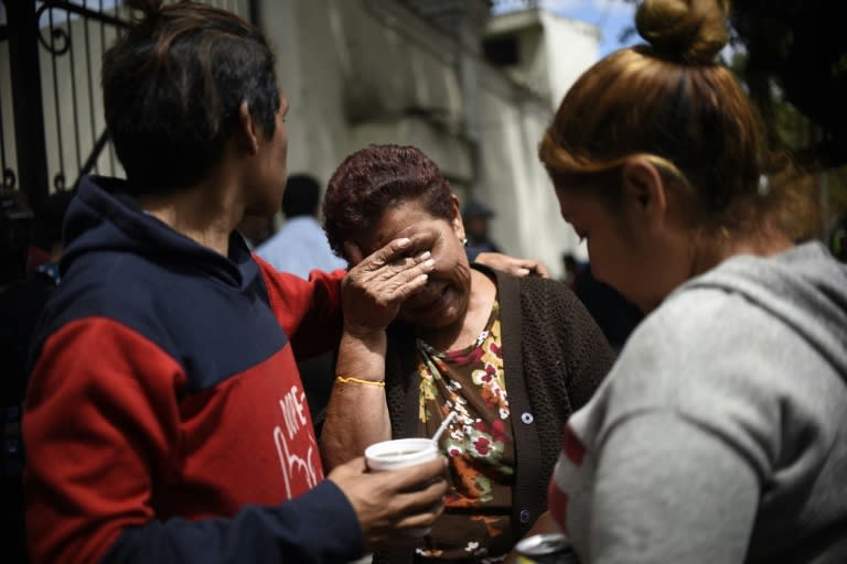 Relatives of the victims of a fire at a government-run children's shelter in San Jose Pinula, cry outside the morgue in Guatemala City