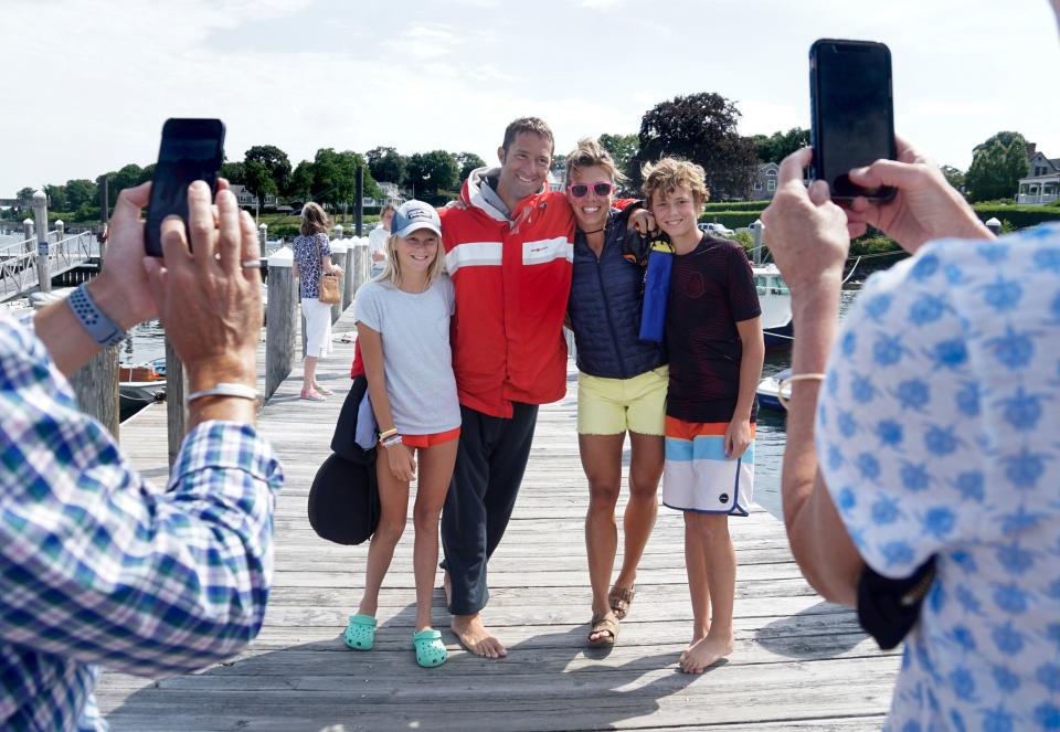 Swimmer Ben Tuff stops at the Jamestown town dock to pose for photos with his family after his 19-mile swim from Block Island to a buoy just off Beavertail State Park last year. From left are are daughter Maise, Tuff, wife Gretchen and son Wyatt.