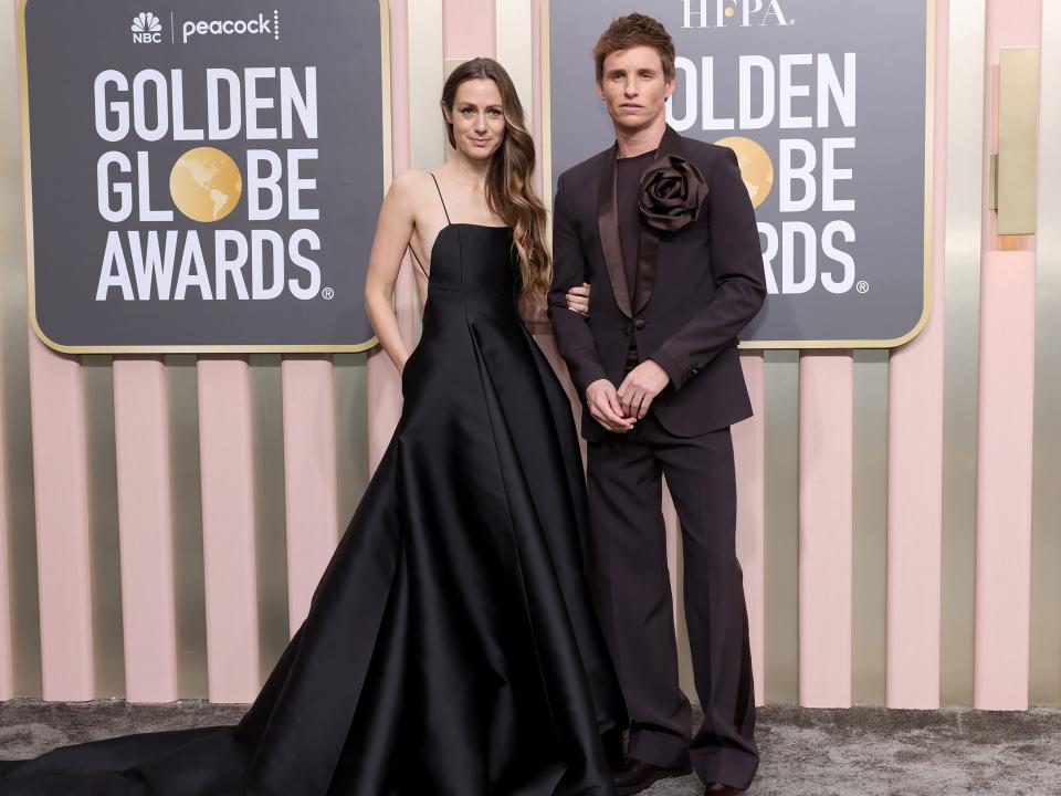 Hannah Bagshawe and Eddie Redmayne walk the red carpet of the 2023 golden globes