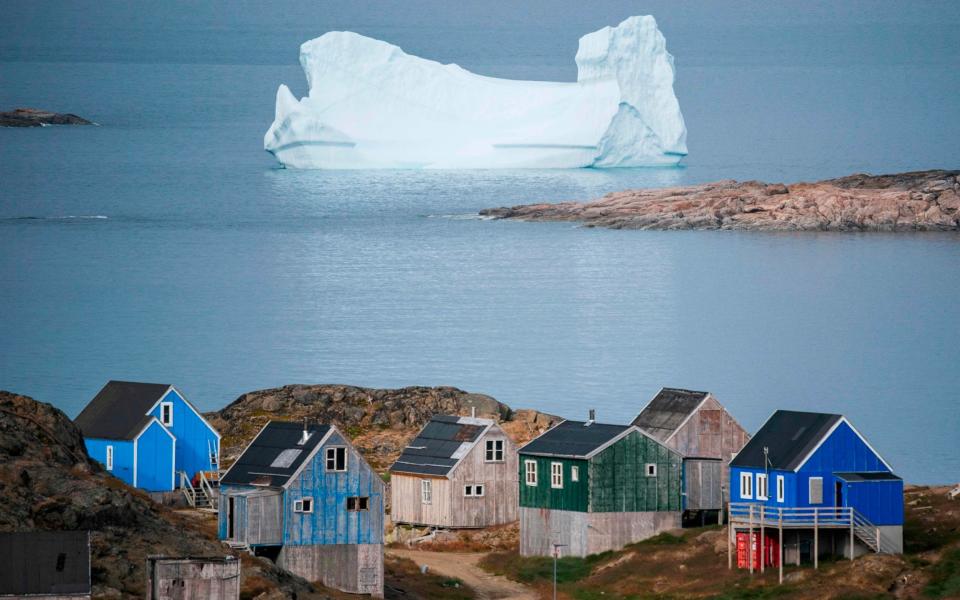 Icebergs float behind the town of Kulusuk in Greenland - AFP