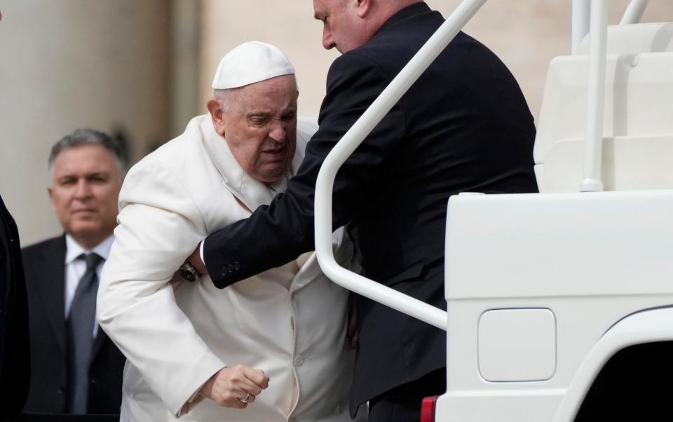 The Pope being helped into the ‘popemobile’ car on Wednesday - Alessandra Tarantino/AP