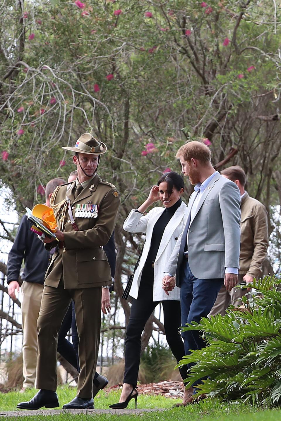 The couple walking hand-in-hand. Photo: Getty