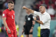 Canada's head coach John Herdman, right, reacts beside Canada's Alistair Johnston, left, during the World Cup group F soccer match between Canada and Morocco at the Al Thumama Stadium in Doha , Qatar, Thursday, Dec. 1, 2022. (AP Photo/Natacha Pisarenko)