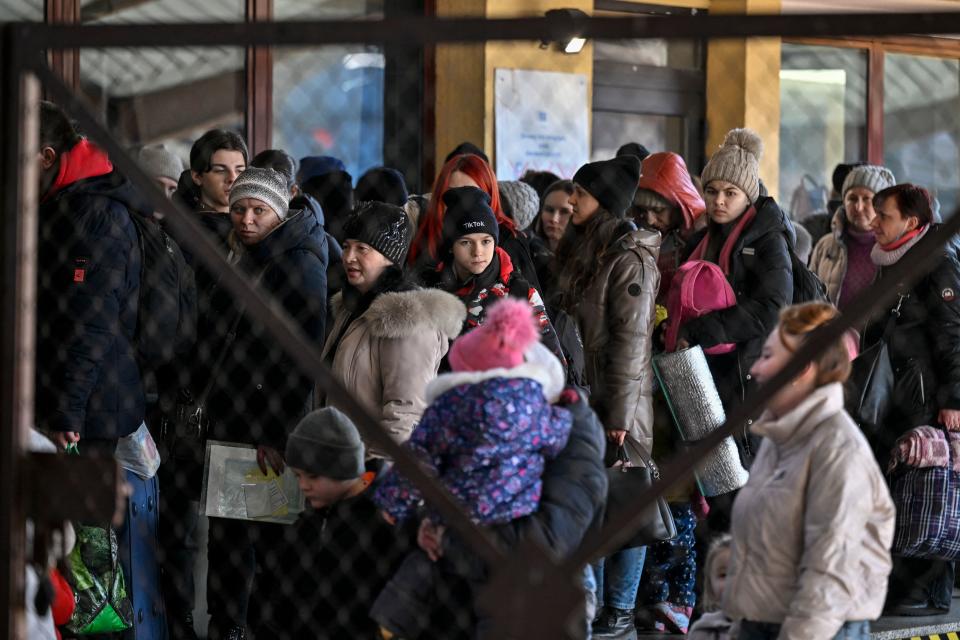 People queue after arriving from Ukraine at the train station in Przemysl, near the Ukrainian-Polish borders on March 14, 2022. - Almost 2.7 million people have fled the war in Ukraine, more than 100,000 of them in the past 24 hours, the UN on March 13, 2022. More than half have gone to Poland. (Photo by Louisa GOULIAMAKI / AFP) (Photo by LOUISA GOULIAMAKI/AFP via Getty Images)