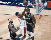 Washington Wizards guard Bradley Beal (3) shoots past New Orleans Pelicans forward Brandon Ingram (14) and forward Zion Williamson (1) in the second quarter of an NBA basketball game in New Orleans, Wednesday, Jan. 27, 2021. (AP Photo/Derick Hingle)