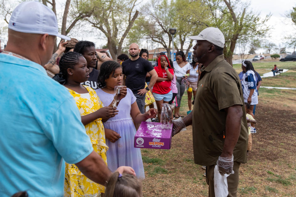 Tremaine Brown passes out candy during Shi Lee's 7th annual Citywide Easter Egg Hunt in April 2023 at Bones Hooks Park in Amarillo.