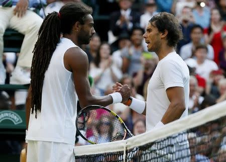 Dustin Brown of Germany shakes hands with Rafael Nadal of Spain after winning their match at the Wimbledon Tennis Championships in London, July 2, 2015. REUTERS/Stefan Wermuth
