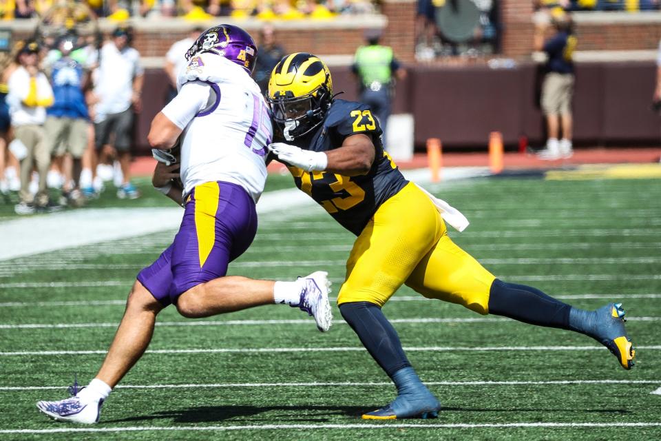 Michigan linebacker Michael Barrett (23) tackles East Carolina quarterback Alex Flinn (15) during the first half at Michigan Stadium in Ann Arbor on Saturday, Sept. 2, 2023.