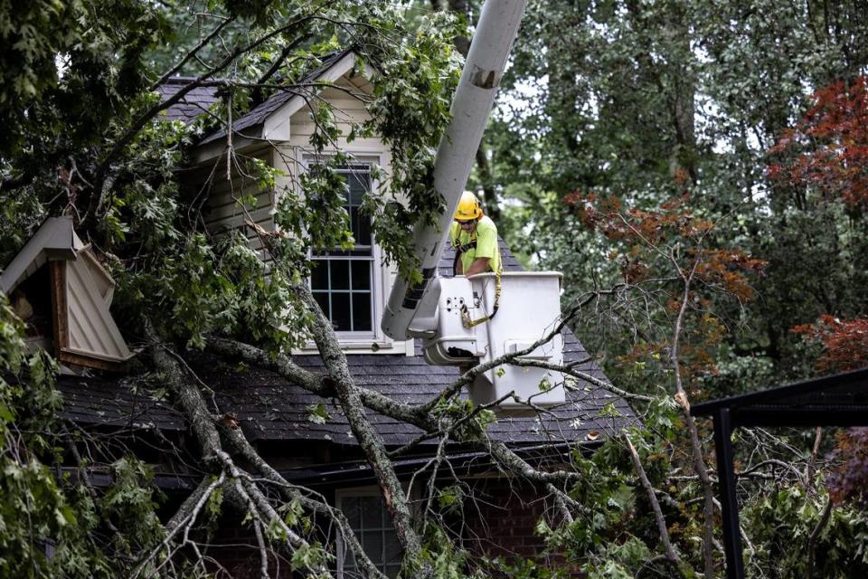 A crew works to clear tornado damage from Scottie Wolds’ home in Harrisburg, NC, on Tuesday, May 24, 2022.