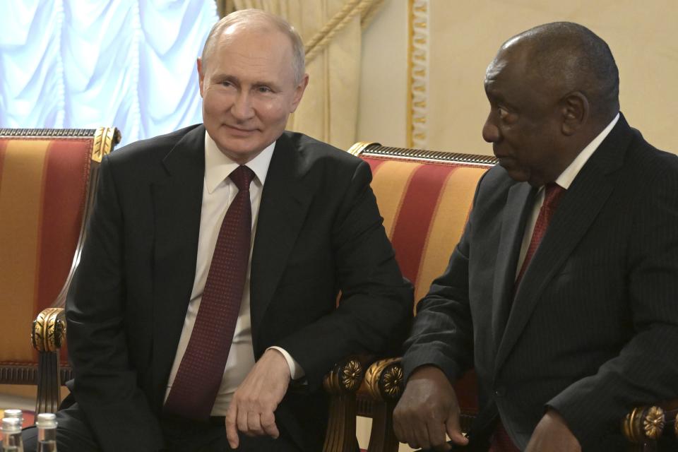 In this handout photo provided by Photo host Agency RIA Novosti, Russian President Vladimir Putin, left, and South African President Cyril Ramaphosa talk to each other during a meeting with a delegation of African leaders and senior officials in St. Petersburg, Russia, Saturday, June 17, 2023. Seven African leaders — presidents of Comoros, Senegal, South Africa and Zambia, as well as Egypt's prime minister and top envoys from the Republic of Congo and Uganda — traveled to Russia on Saturday a day after visiting Ukraine on a mission to try to help end the hostilities. (Evgeny Biyatov/Photo host Agency RIA Novosti via AP)