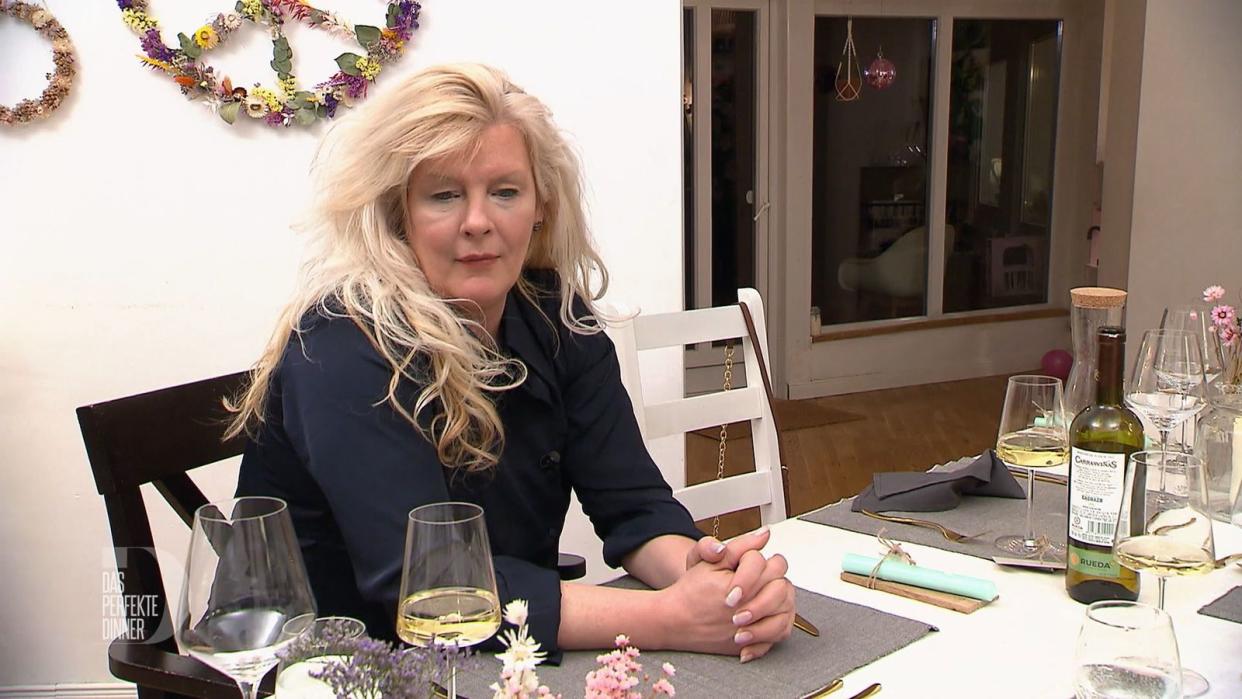 Kira bleibt bei ihrem Wein am Tisch sitzen. Das Verhalten stößt auf Unverständnis.
 (Bild: RTL)