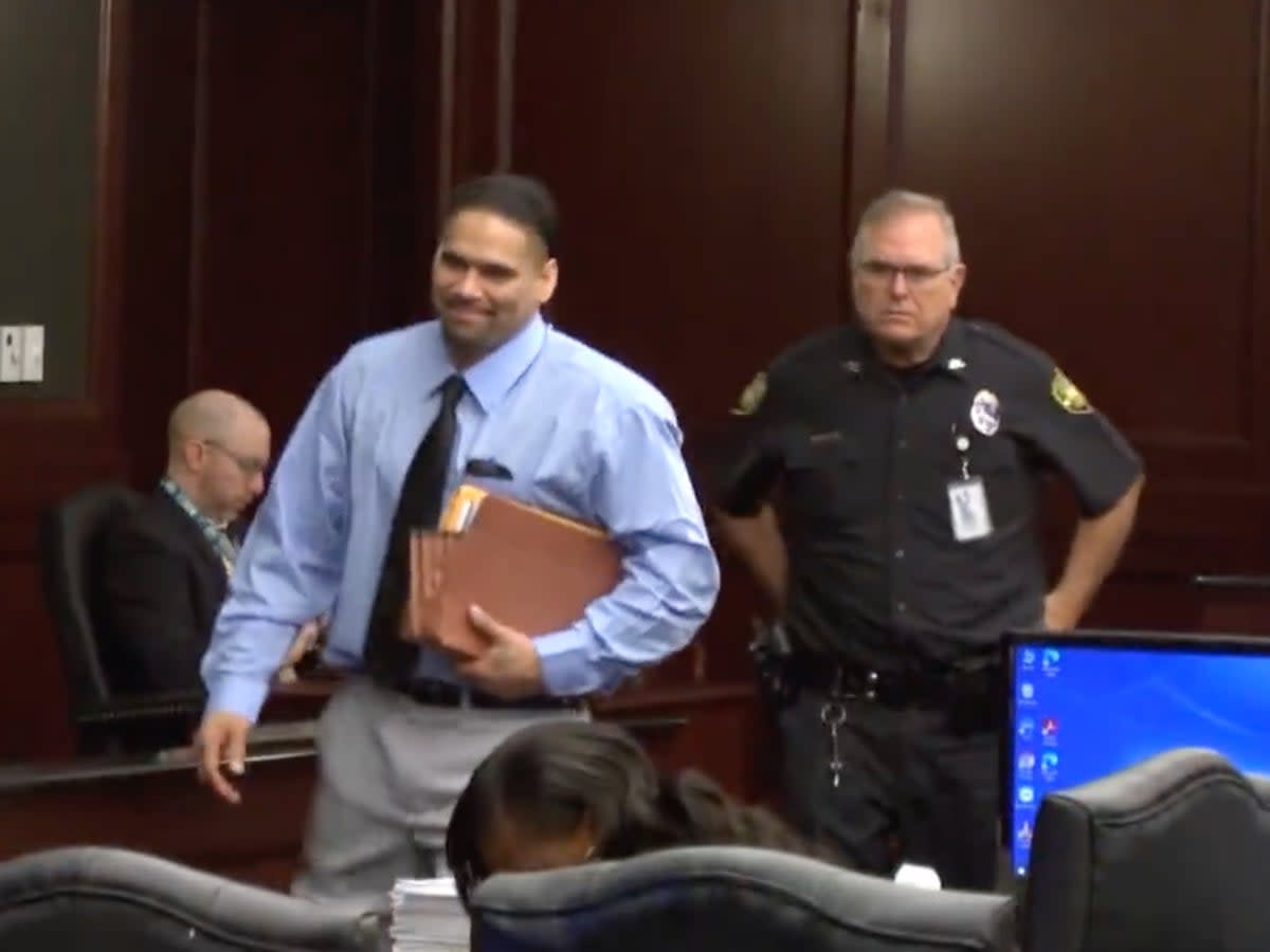 Johnathan Quiles, 38, smiles as he enters court, where he was charged with the first-degree murder of his niece, Iyana Sawyer, 16, who was pregnant with his child (screengrab/FCN2Go News)