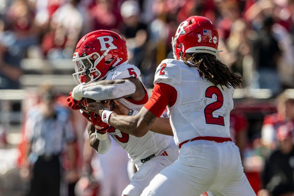 Oct 21, 2023; Bloomington, Indiana, USA; Rutgers Scarlet Knights running back Kyle Monangai (5) takes a hand off from Rutgers Scarlet Knights quarterback Gavin Wimsatt (2) during the second quarter against the IIndiana Hoosiers at Memorial Stadium. Mandatory Credit: Marc Lebryk-USA TODAY Sports